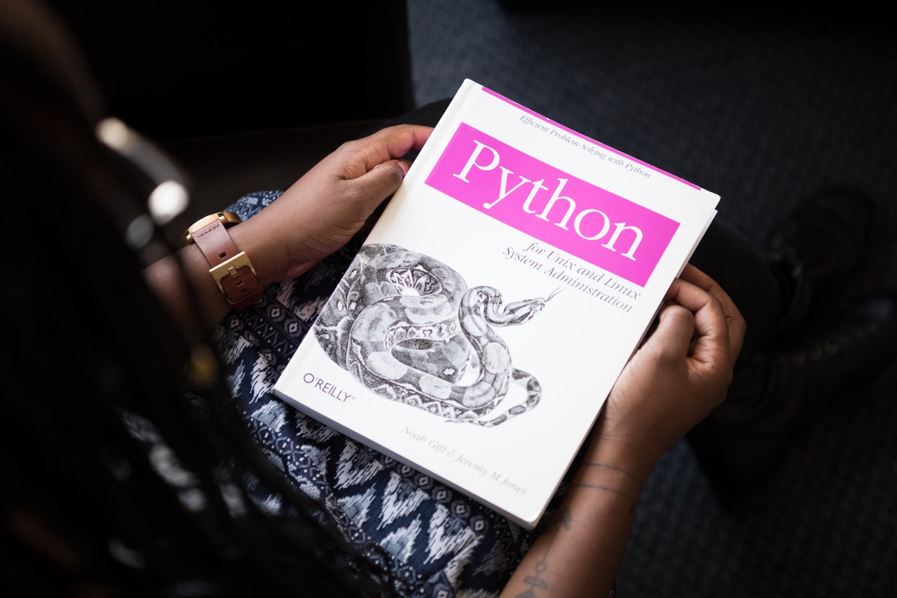 Woman holding python book